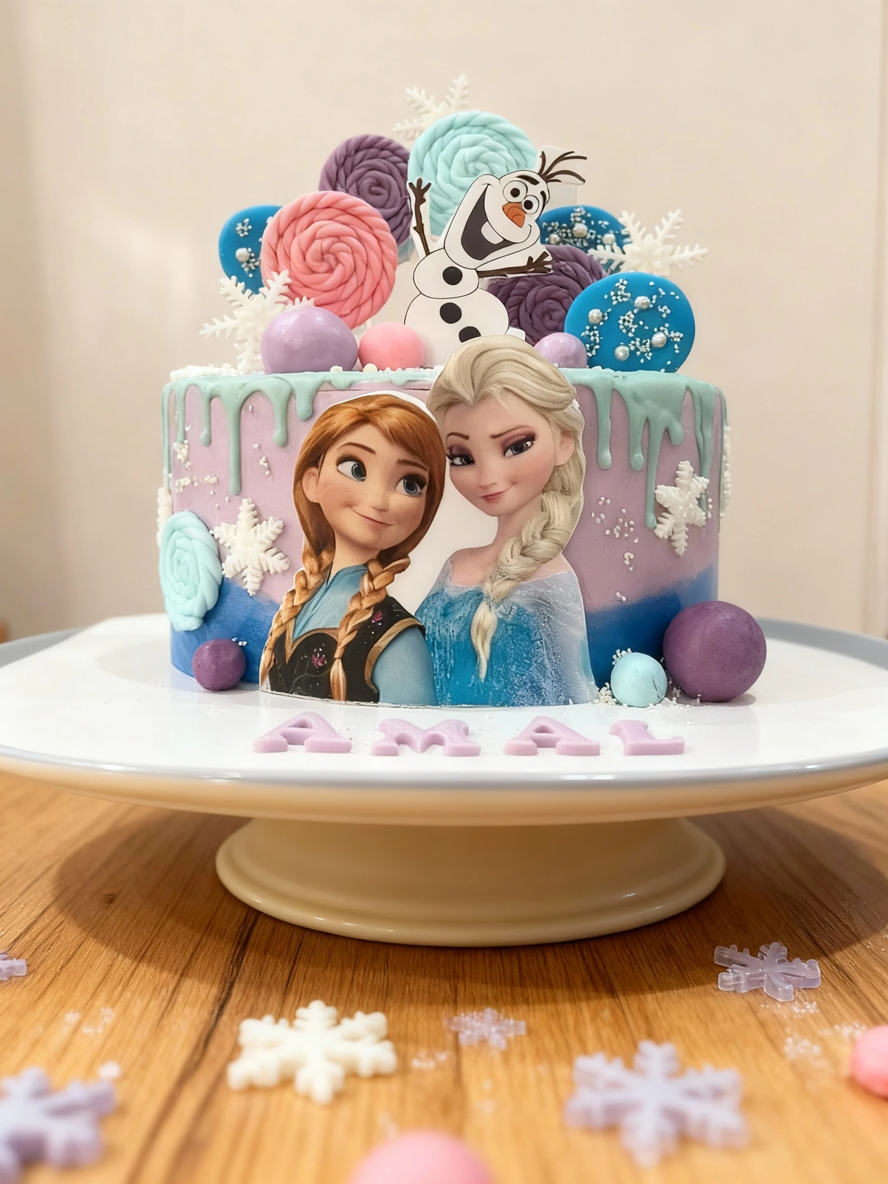A round birthday cake themed after the movie Frozen, featuring purple and blue-green ombré icing with a light green drip effect. The cake is decorated with edib