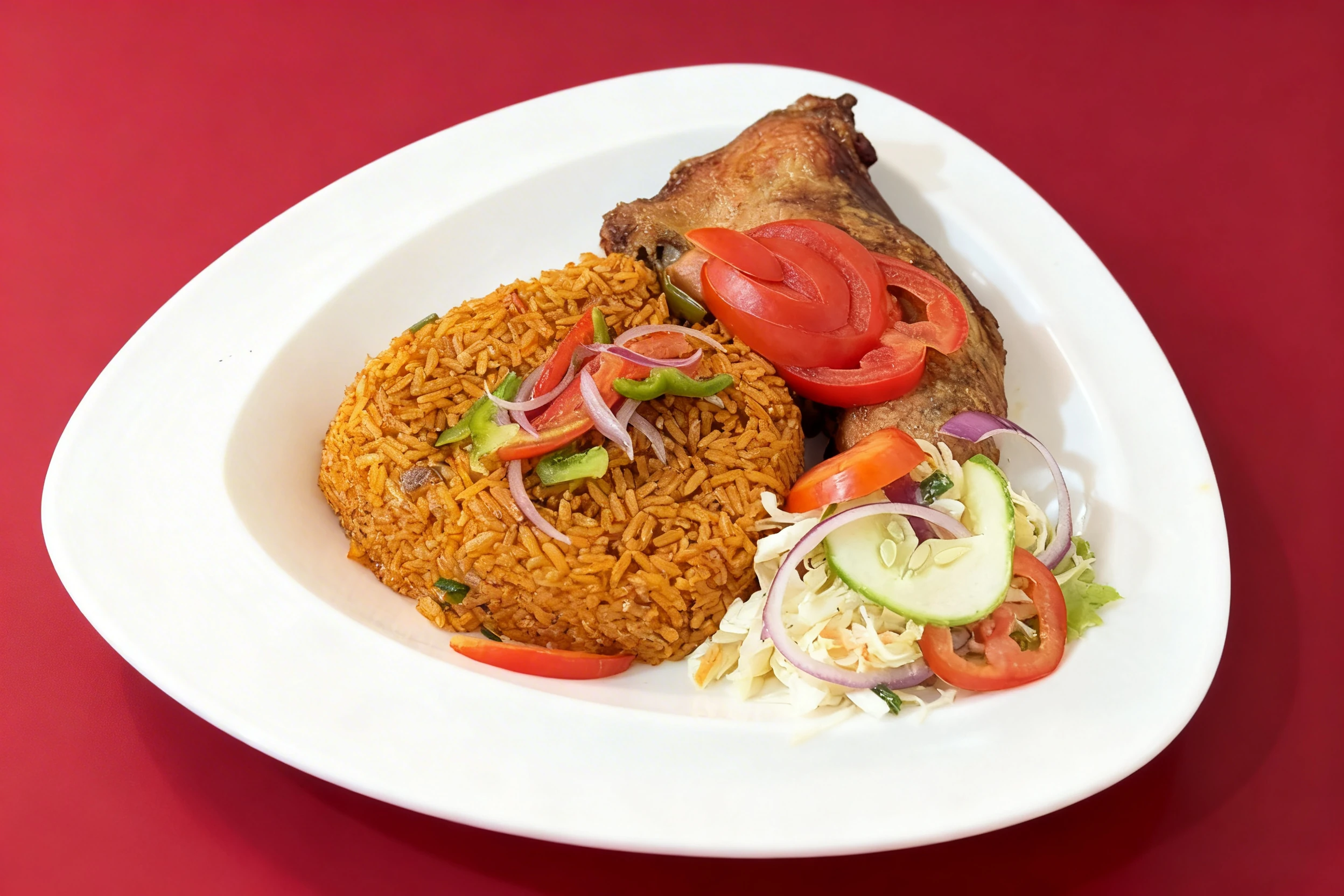 Jollof rice topped with sliced peppers and onions, served with a roasted chicken quarter and a side salad of cucumber, tomato, and cabbage.