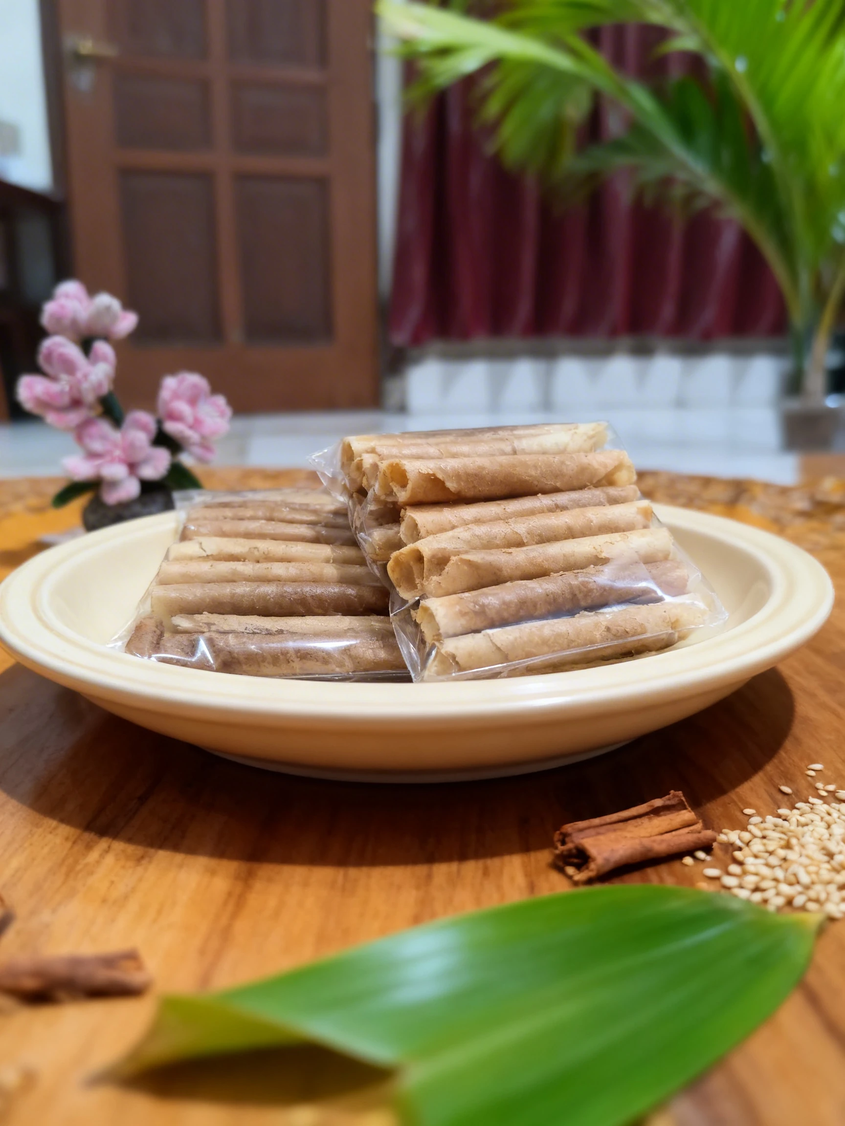 Several packs of thin, rolled crispy crepes (Kue Semprong) stacked together.