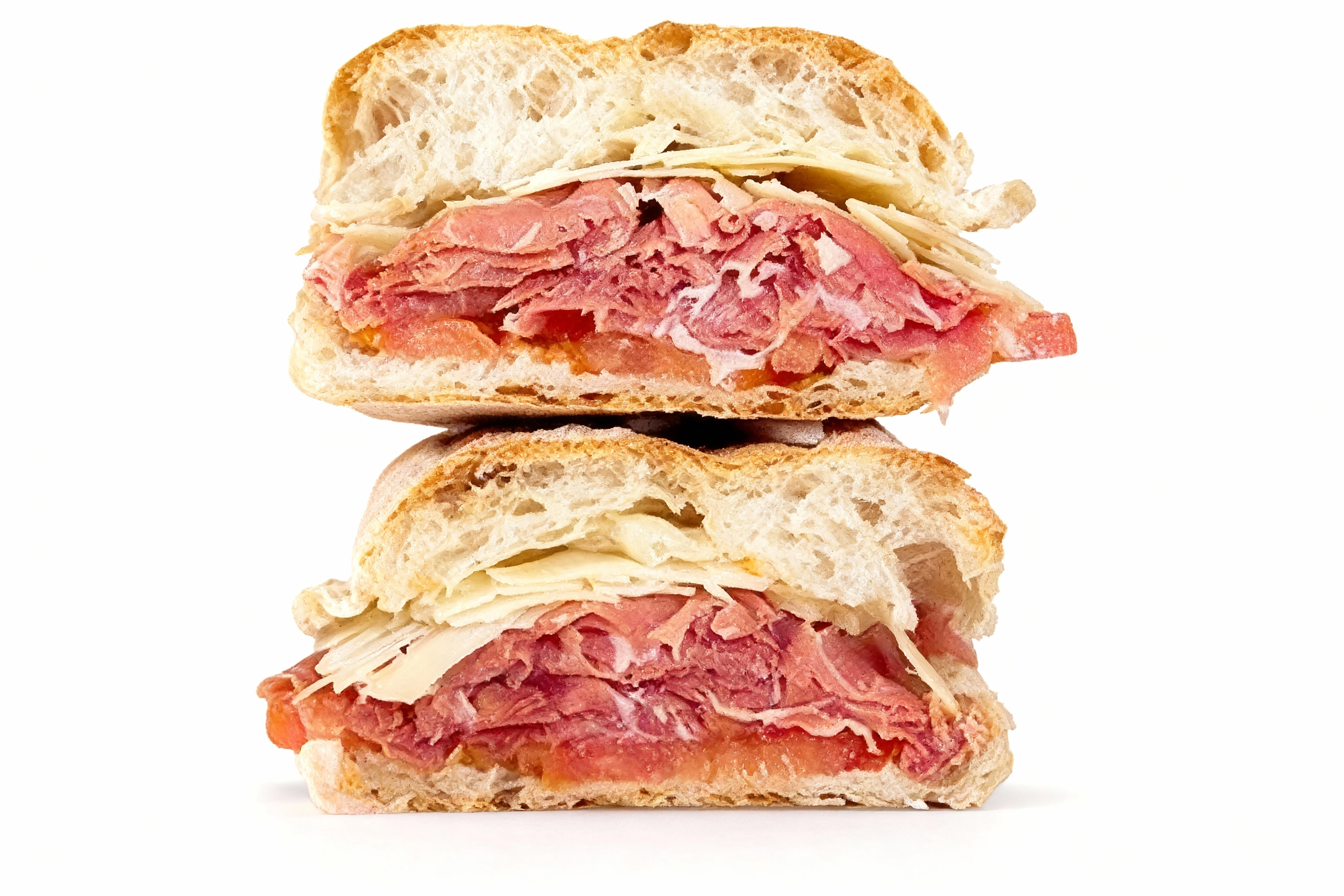 A stacked ciabatta sandwich filled with thinly sliced roast beef, shaved parmesan cheese, and tomato slices.