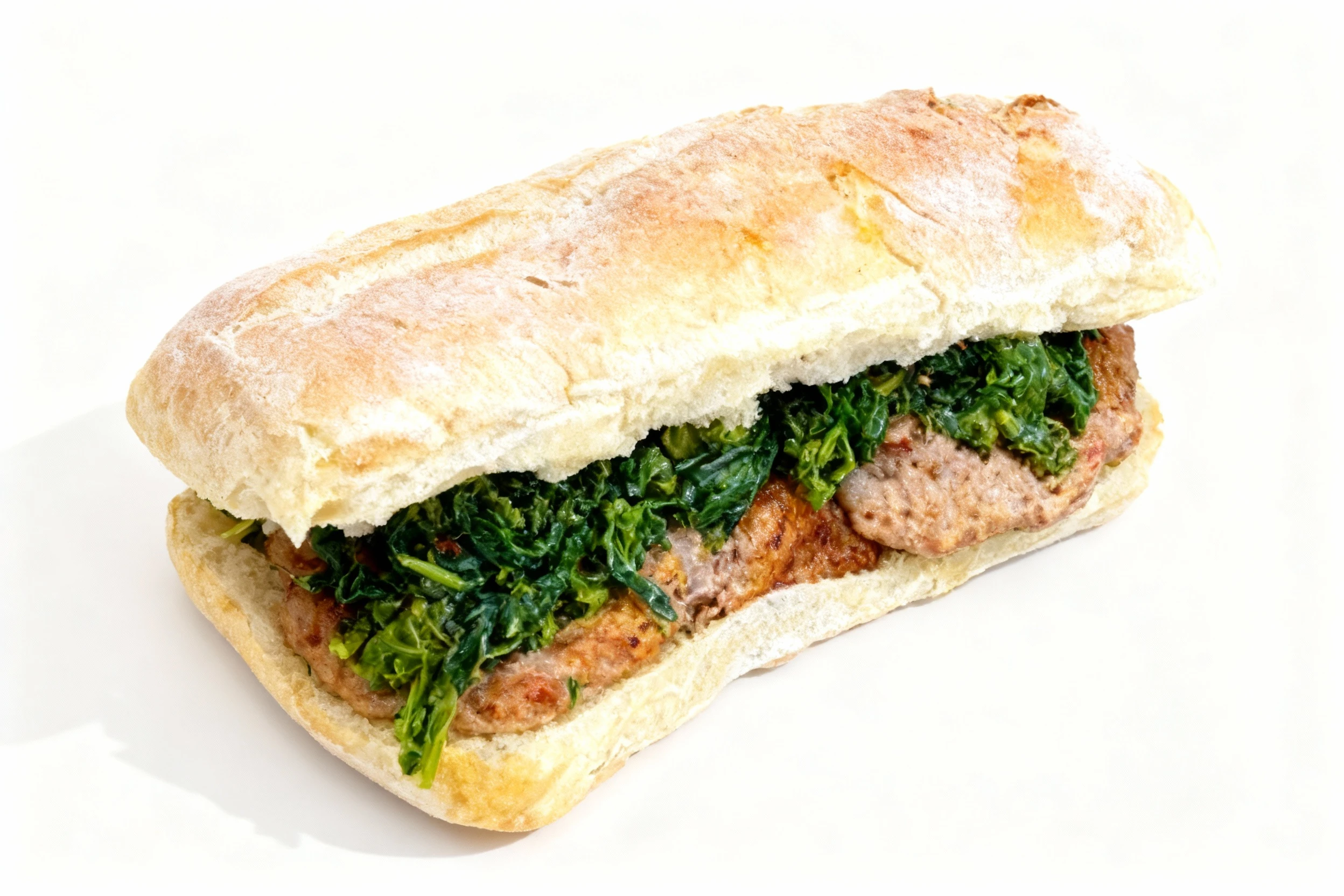 A ciabatta sandwich filled with grilled sausage patties and sautéed leafy greens, likely rapini or spinach.