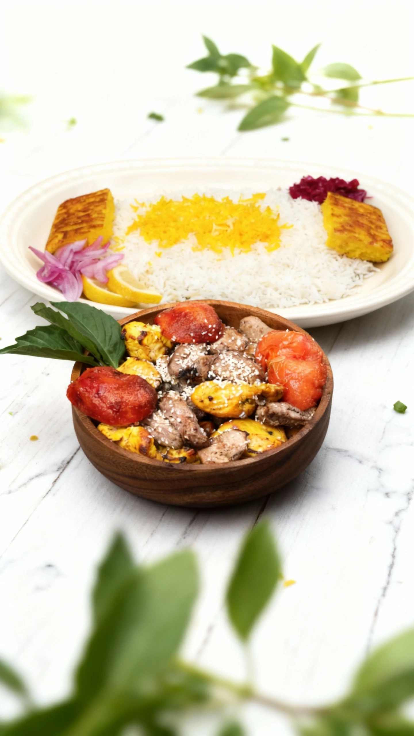 Persian-style platter featuring basmati rice topped with saffron rice and crispy tahdig, garnished with lemon and pickled onions, served alongside a bowl of mix